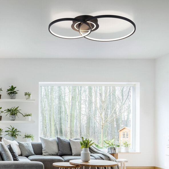 Schwarze, runde LED-Deckenleuchte ASMINA mit indirekter Beleuchtung. Die Leuchte besteht aus einem äußeren Ring und einer zentralen, flachen Scheibe. Helles Licht wird nach oben und unten abgestrahlt.