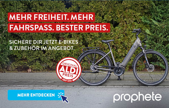 Fahrrad steht vor einer Hecke, Prophete Logo daneben