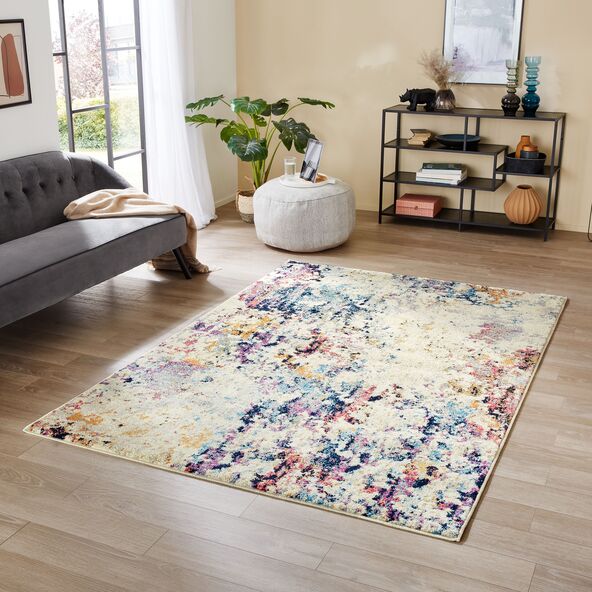 Farbenfroher Teppich mit geometrischen Mustern in verschiedenen Farben wie Gelb, Blau, Grün und Orange. Die Muster sind unregelmäßig angeordnet und wirken modern.
