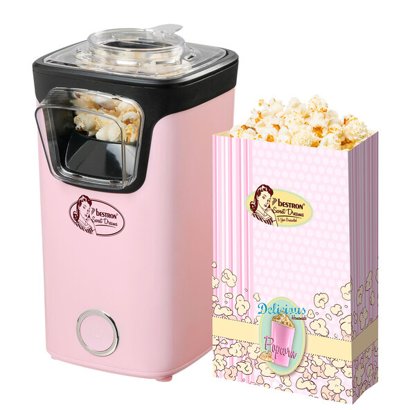 Popcornmaschine in Pink, freigestellt vor weißem Hintergrund. Die Maschine hat ein transparentes Gehäuse und einen roten Messbecher.