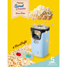 Blaue Popcornmaschine mit transparentem Behälter und rotem Messlöffel, steht auf einer weißen Oberfläche. Das Produkt wirkt neu und unbenutzt.
