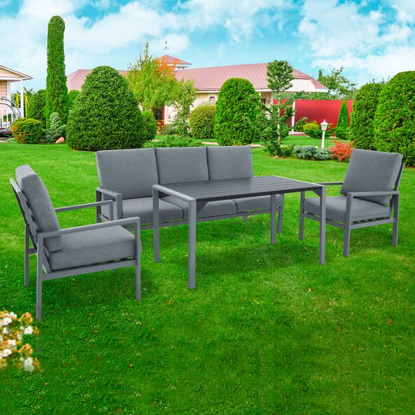 Alu Lounge Sitzgruppe mit grauem Aluminiumgestell, bestehend aus Sofa, Sesseln und Tisch mit grauer Tischplatte, auf einer Terrasse.