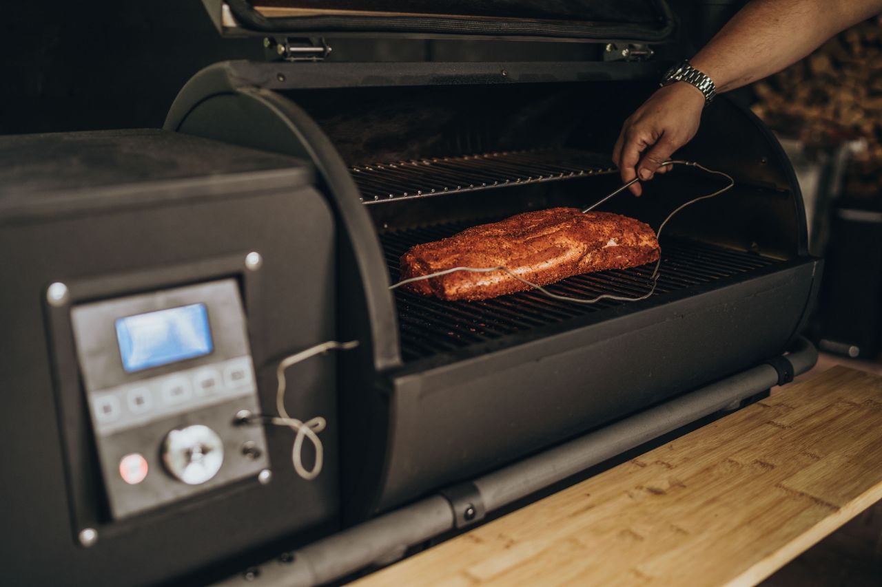 Mit Gewürzen marinierter Schweinenacken liegt auf dem Grill.