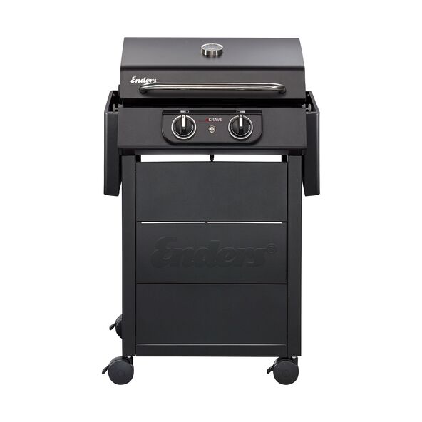 Elektrogrill Crave auf einem Tisch, schwarzes Gehäuse, Grillrost aus Metall, Bedienelemente vorne, Hintergrund unscharf.