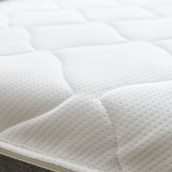 Graues Boxspringbett Basic (180x200cm) mit geradlinigem Kopfteil steht auf dunklen Füßen. Die Matratze ist mit einem helleren Stoff bezogen.